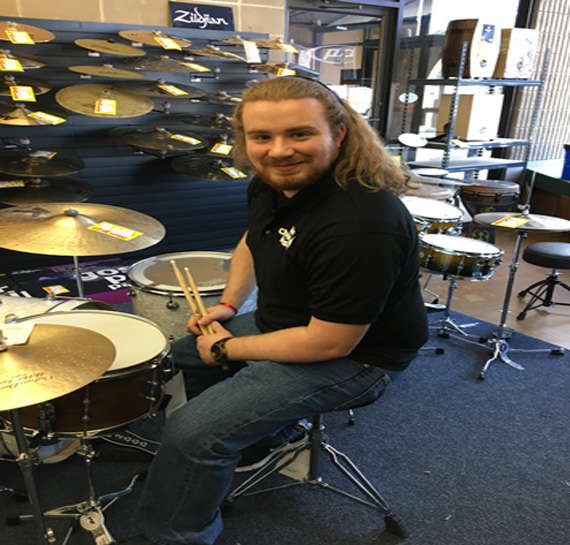 Click to view a larger image of Matt amongst our large selection of percussion instruments!